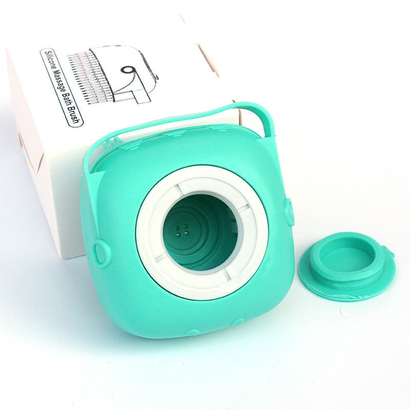 turquoise silicone dog bath massage glove with shampoo dispenser and handle next to white packaging box