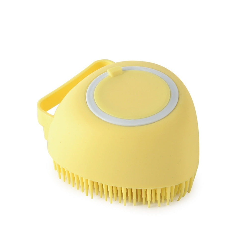 Yellow silicone dog bath brush with soft bristles and handle for gentle pet grooming and massage